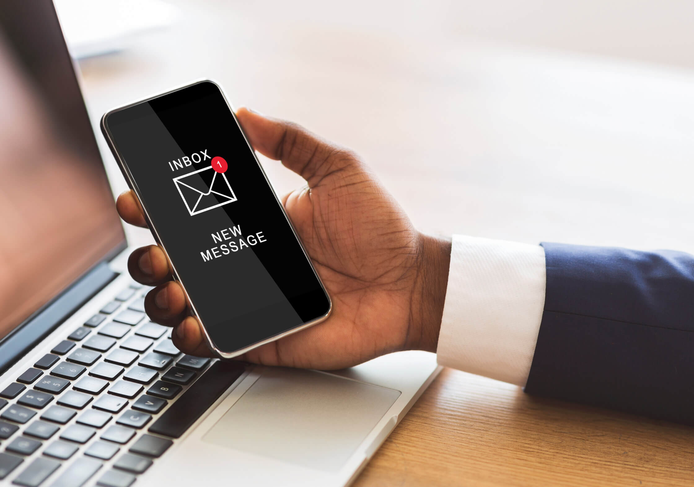 Black Businessman Holding Smartphone Reading E-Mail Message In Office